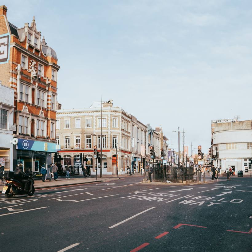 Corner shopfronts at a wide road junction