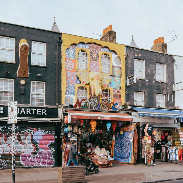 Mural-painted market shopfront selling rugs and clothing