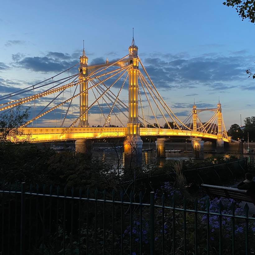 Illuminated bridge over the Thames at dusk