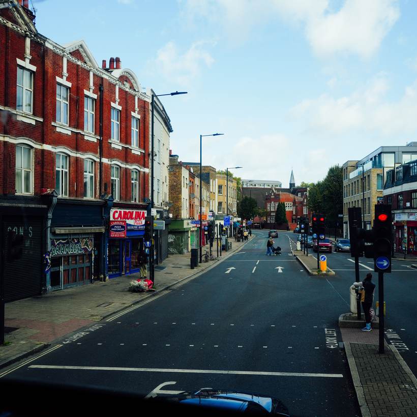Wide high street with shopfronts and traffic