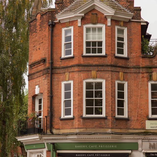Red-brick corner building with a bakery cafe below