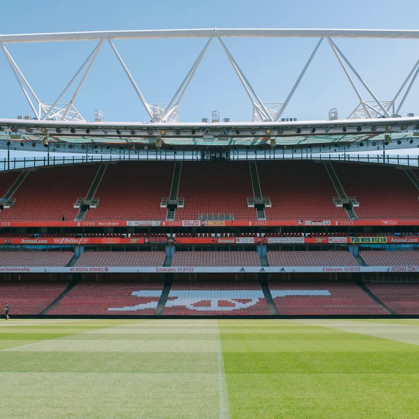 Empty stadium bowl with a green pitch