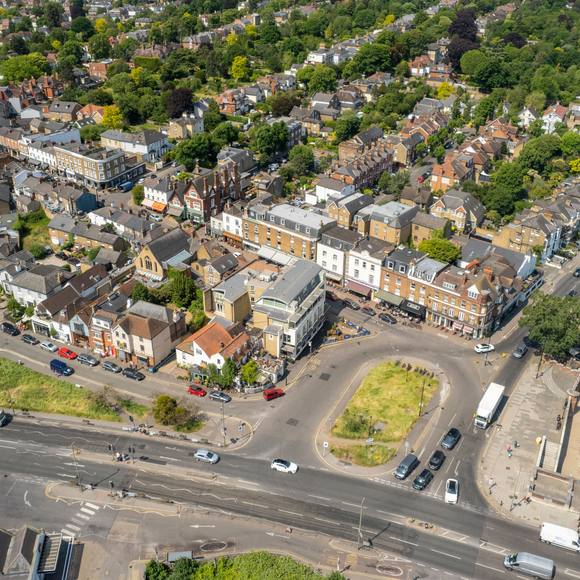 Aerial view of a riverside high street and moored boats