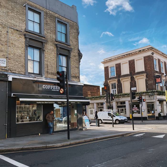 Coffee shop and corner pub at a sunny street junction