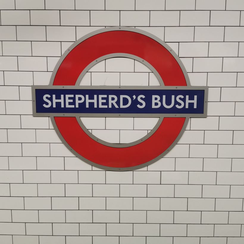 Underground roundel on a tiled station wall