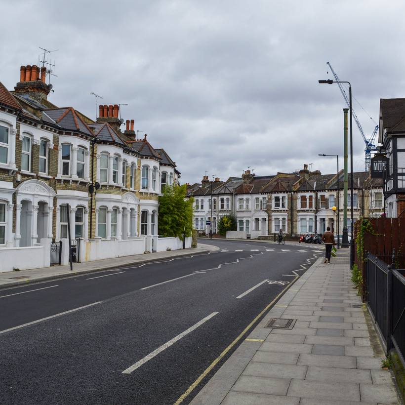 Long Victorian terraced street with an empty road
