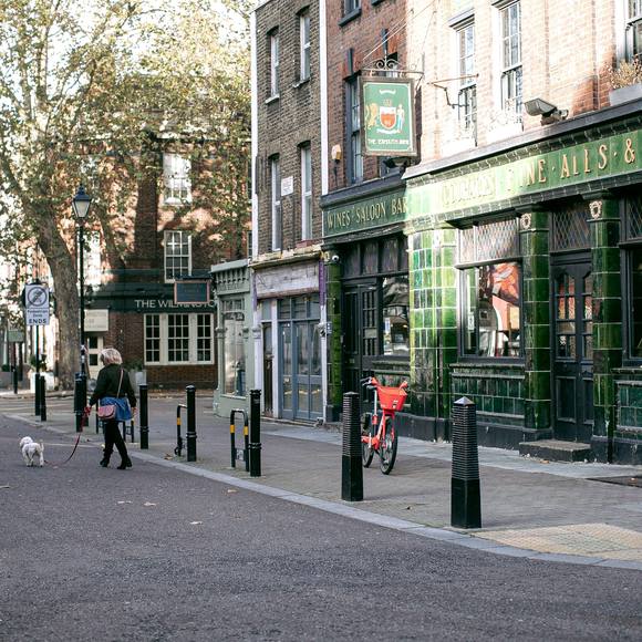 Green-tiled Victorian pub facade with leaded windows